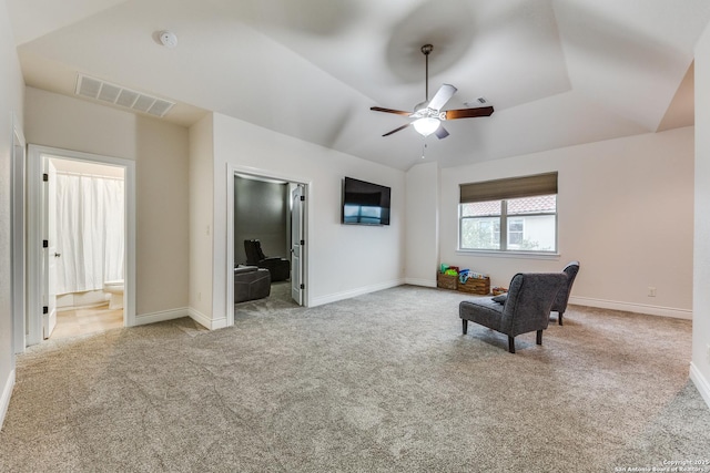 sitting room with carpet floors, lofted ceiling, visible vents, and baseboards