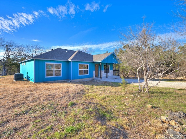 single story home featuring a front yard and central AC unit