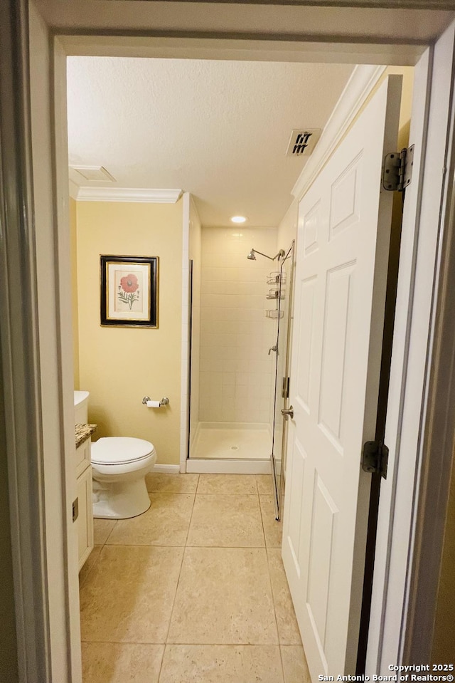 full bath featuring toilet, a textured ceiling, a shower stall, vanity, and tile patterned floors