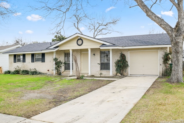 single story home featuring brick siding, concrete driveway, covered porch, an attached garage, and a front yard