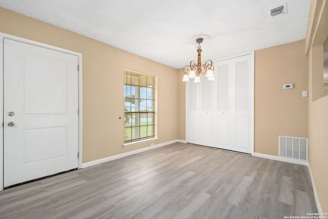 interior space featuring wood finished floors, visible vents, and baseboards