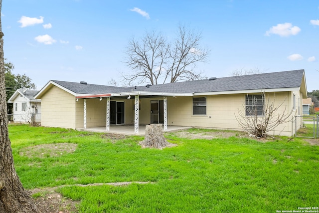 back of house with a patio, a lawn, and fence