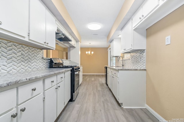 kitchen with light wood-style flooring, a sink, baseboards, white cabinets, and stainless steel range with gas stovetop