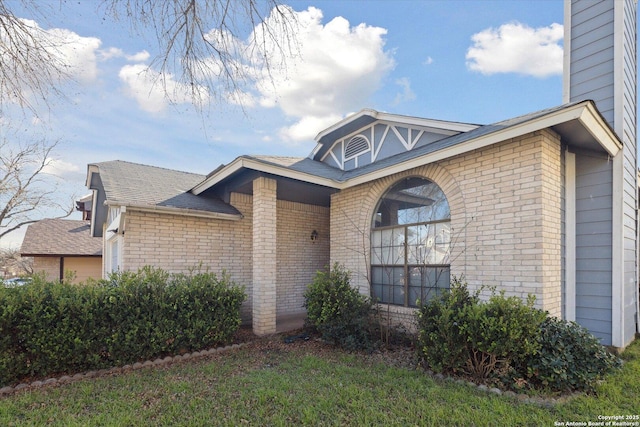 view of property exterior featuring brick siding