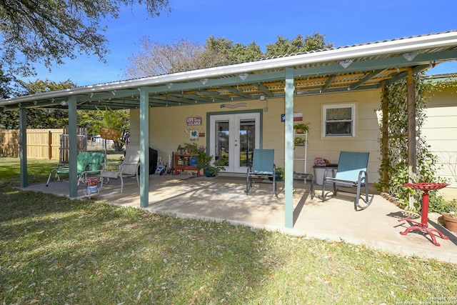 back of house with french doors, a patio area, fence, and a lawn