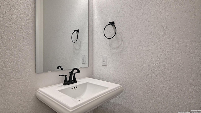 12326 Fort Jyn, San Antonio, TX 78245 - bathroom with a textured wall and a sink
