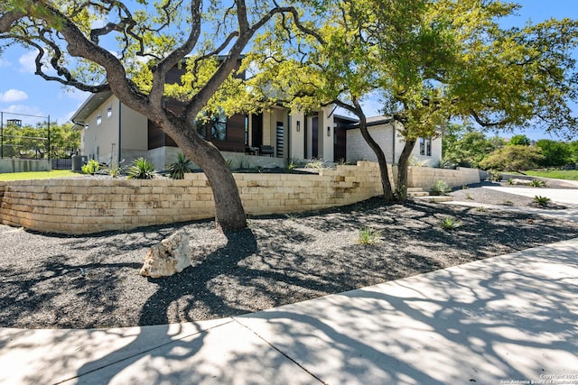 view of side of property featuring fence