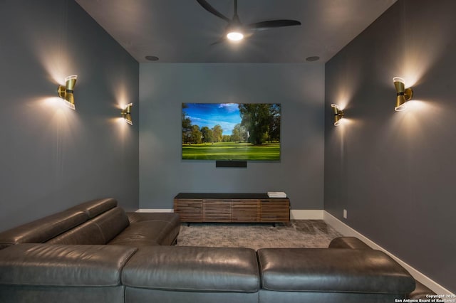 home theater room with a ceiling fan, carpet floors, and baseboards