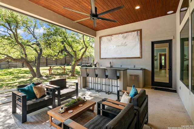 view of patio / terrace featuring ceiling fan, fence, and an outdoor living space