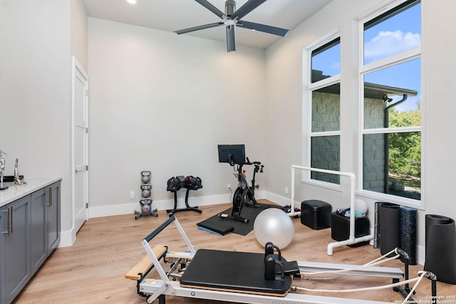 exercise area featuring recessed lighting, light wood-type flooring, a ceiling fan, and baseboards