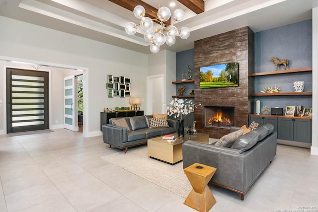 living room with light tile patterned floors, a large fireplace, baseboards, beam ceiling, and an inviting chandelier