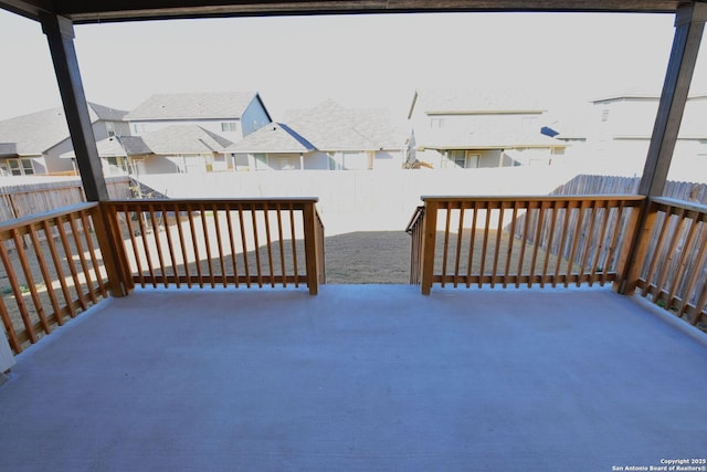 deck featuring a patio area, a fenced backyard, and a residential view