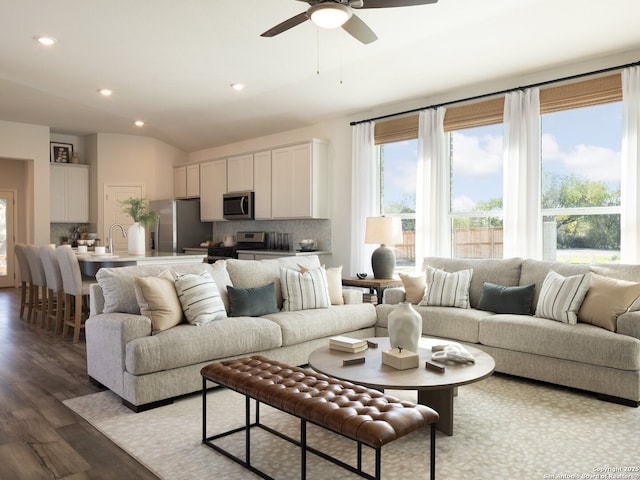 living room featuring lofted ceiling, wood finished floors, a ceiling fan, and recessed lighting