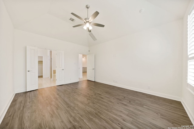 unfurnished bedroom with ceiling fan, wood finished floors, visible vents, baseboards, and vaulted ceiling