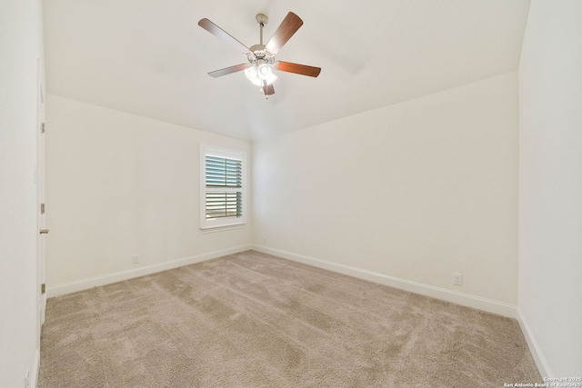 spare room with baseboards, a ceiling fan, and light colored carpet