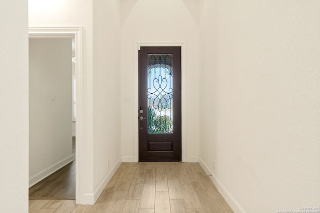 entryway featuring light wood-type flooring and baseboards