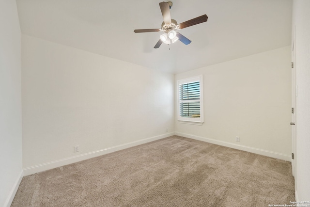 spare room featuring baseboards, a ceiling fan, and light colored carpet