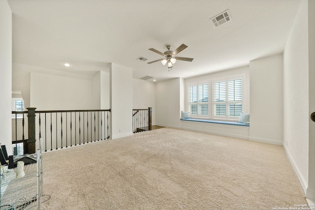 carpeted empty room featuring a ceiling fan, recessed lighting, visible vents, and baseboards