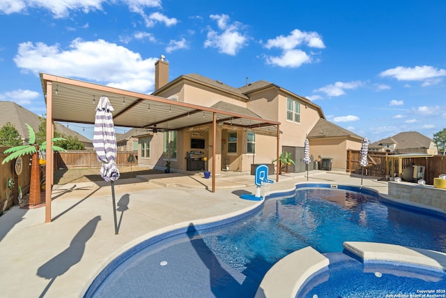 view of pool with a fenced backyard, a pool with connected hot tub, area for grilling, and a patio