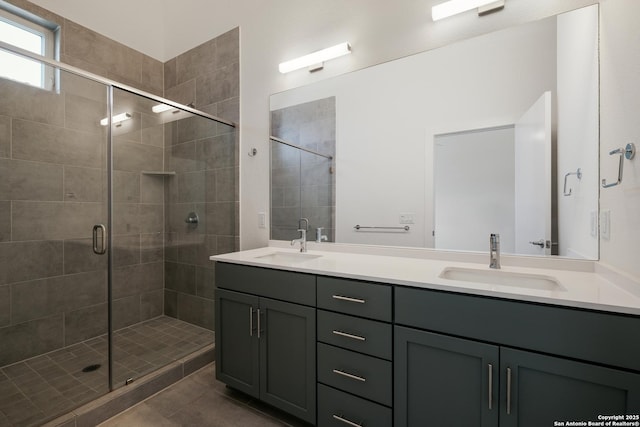 full bath with a stall shower, tile patterned flooring, a sink, and double vanity