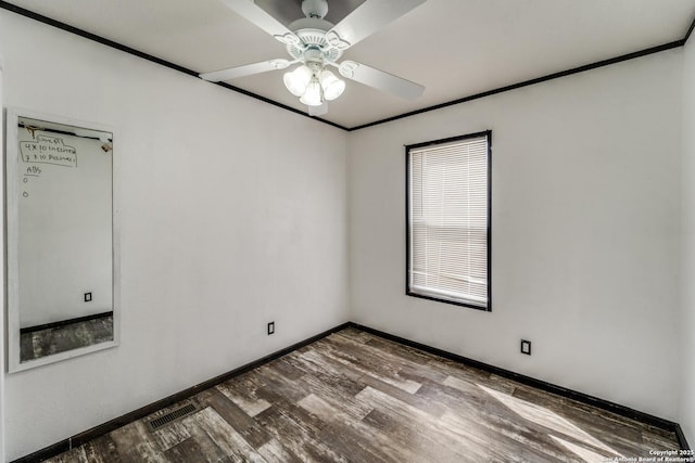 empty room with visible vents, baseboards, ceiling fan, wood finished floors, and crown molding