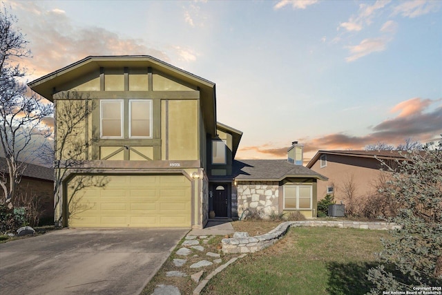 view of front of house featuring concrete driveway, stone siding, a chimney, an attached garage, and stucco siding