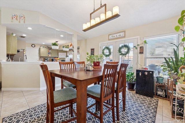 dining room featuring light tile patterned floors, french doors, vaulted ceiling, and recessed lighting