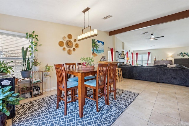 dining room with visible vents, ceiling fan, lofted ceiling with beams, and light tile patterned flooring