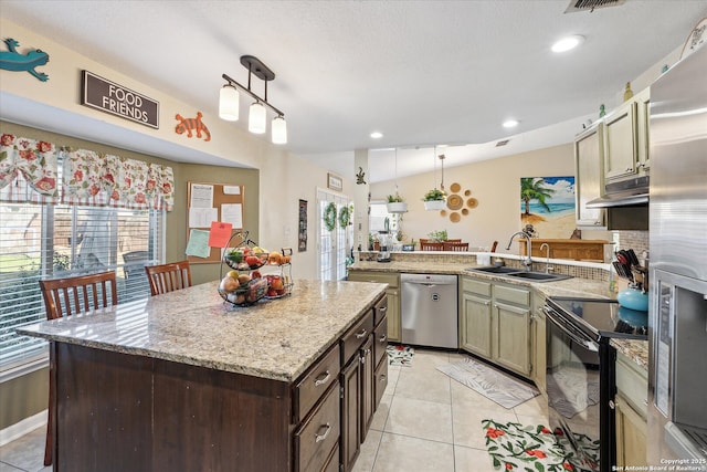 kitchen with light tile patterned floors, appliances with stainless steel finishes, a peninsula, under cabinet range hood, and a sink