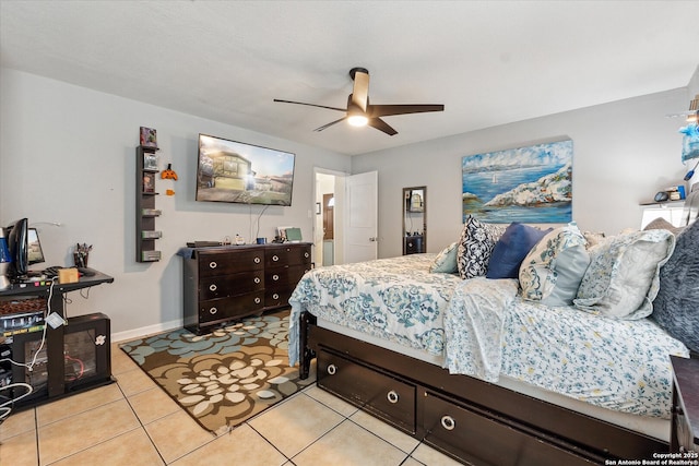 bedroom with ceiling fan, baseboards, and light tile patterned floors