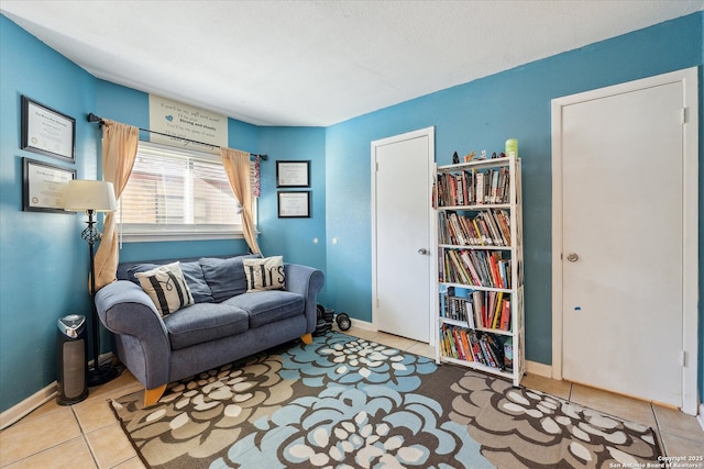 sitting room featuring baseboards and tile patterned floors