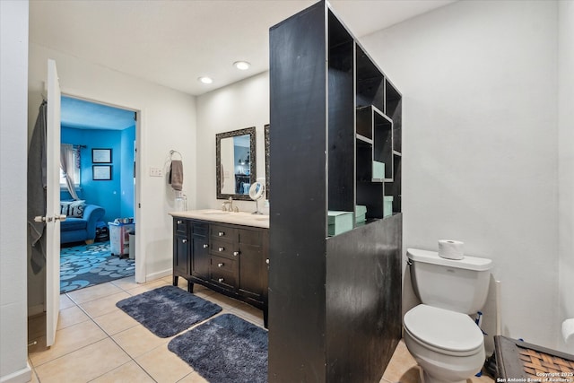 bathroom with ensuite bathroom, toilet, recessed lighting, vanity, and tile patterned floors