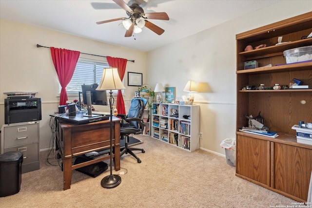 office area with carpet flooring, ceiling fan, and baseboards