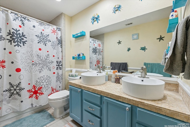 full bath featuring double vanity, visible vents, toilet, tile patterned flooring, and a sink