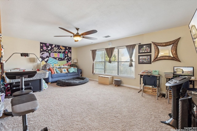 interior space featuring a textured ceiling, ceiling fan, carpet floors, visible vents, and baseboards