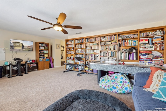 carpeted office space with a ceiling fan and visible vents