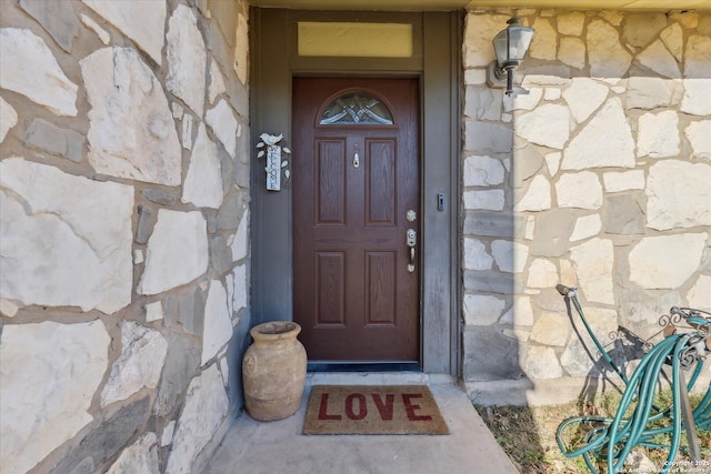 doorway to property with stone siding