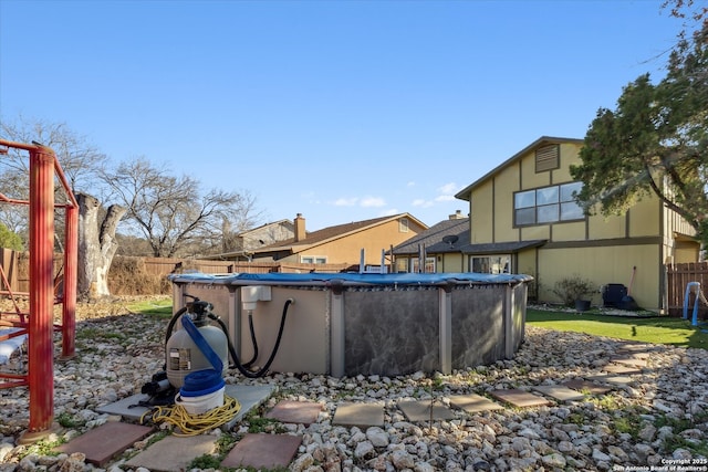 view of yard with a fenced in pool and fence