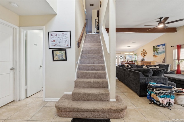 staircase featuring visible vents, baseboards, lofted ceiling with beams, ceiling fan, and tile patterned floors