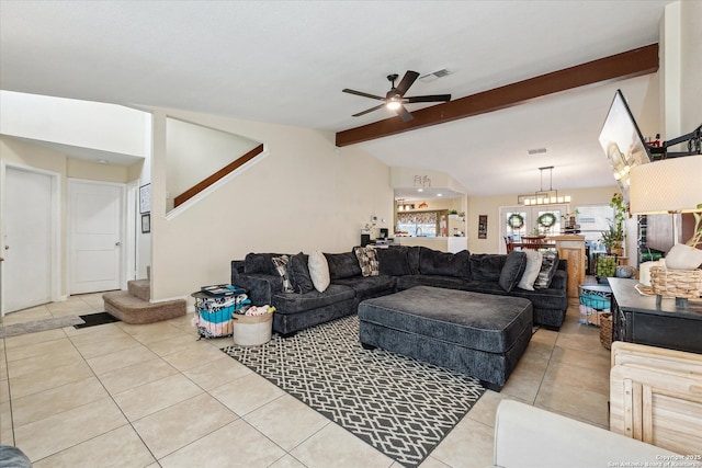 tiled living area with lofted ceiling with beams, ceiling fan with notable chandelier, stairs, and visible vents