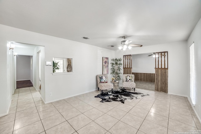 unfurnished room with light tile patterned floors, visible vents, and a ceiling fan