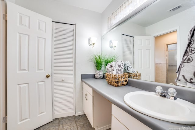 bathroom with a closet, visible vents, and vanity