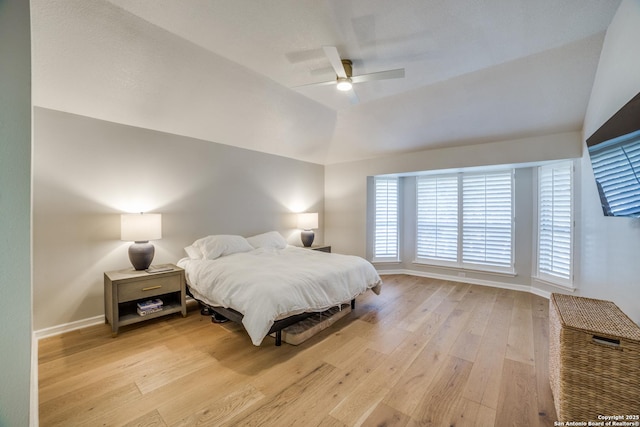 bedroom featuring lofted ceiling, hardwood / wood-style flooring, ceiling fan, and baseboards