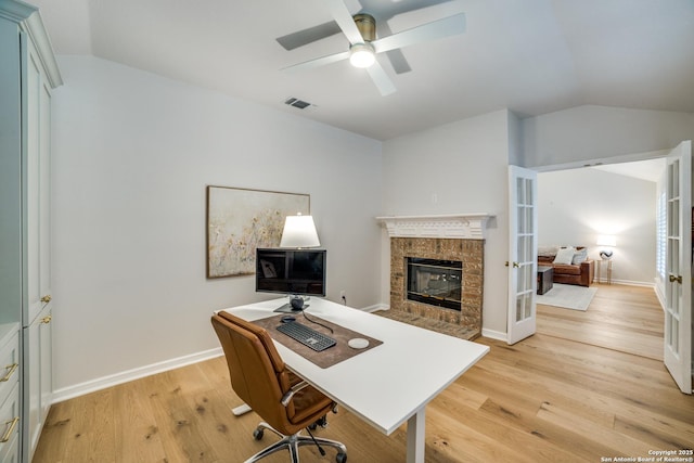 office featuring light wood-style floors, french doors, visible vents, and vaulted ceiling