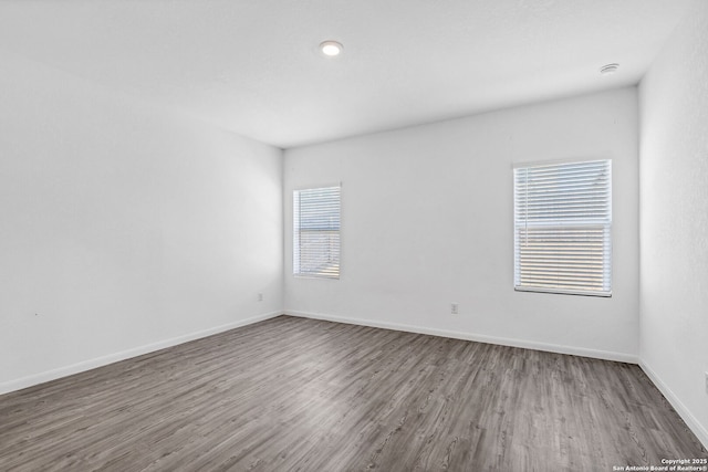 unfurnished room featuring wood finished floors and baseboards