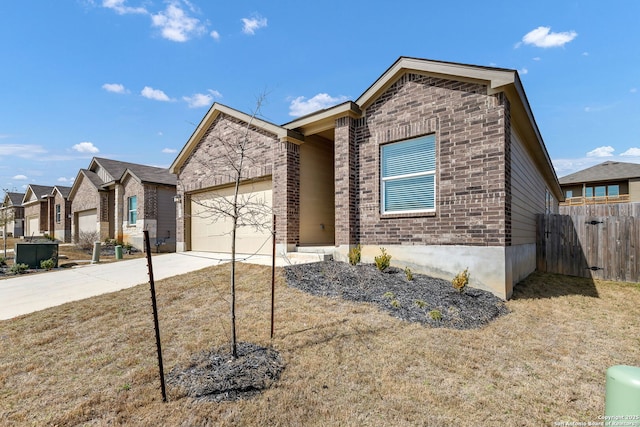 view of front of property featuring concrete driveway, brick siding, an attached garage, and fence