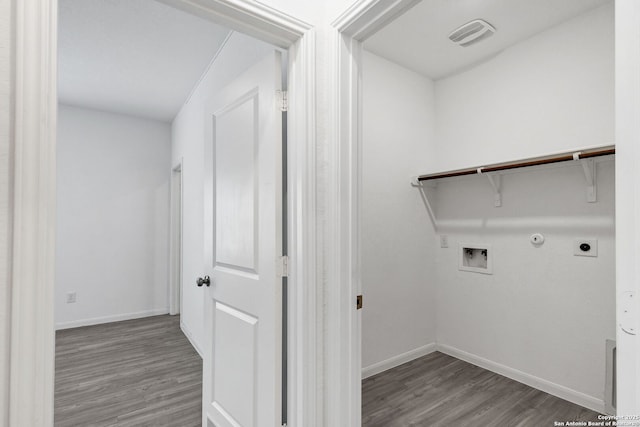 washroom featuring washer hookup, hookup for an electric dryer, baseboards, and wood finished floors