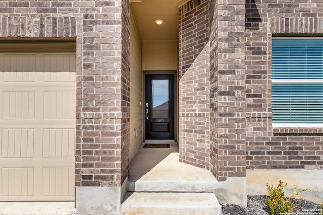 doorway to property with brick siding