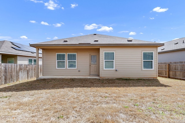 rear view of property with a fenced backyard