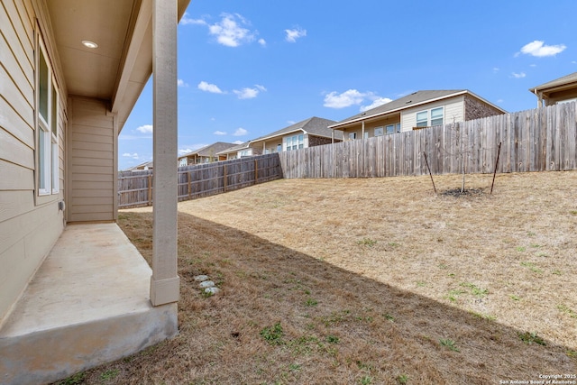 view of yard featuring a patio area and a fenced backyard